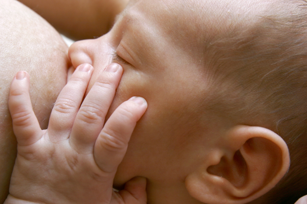 Do I need to hold my breast when breastfeeding?